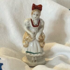 Porcelain Girl Figurine with Red Bow and Gold Accents Woman in Antique Dress